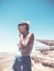 A young beautiful happy girl looks at Mitzpe Ramon, Negev desert, Israel