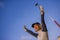 Young beautiful and happy golf player woman smiling raising arms in victory sign holding club and ball winning tournament or just