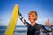 Young beautiful and happy surfer woman holding yellow surf board smiling cheerful enjoying summer holidays in tropical beach