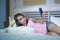 Young beautiful and happy woman on bed smiling and flirting on internet social media app using mobile phone cheerful and relaxed o