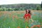 Young beautiful happy woman have a fun in spring poppy field. Concept freedom and happiness summer