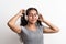 Young beautiful happy woman with headphones in studio, eyes closed.