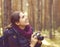 Young, beautiful and happy woman walking in forest and taking pi