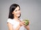 Young, beautiful and healthy teenage girl with a bowl of green s