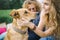 Young beautiful hippie couple with dog in nature