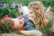 Young beautiful hippie couple lying on grass having fun