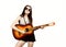 Young beautiful hippie playing guitar on light background