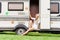 Young and beautiful hippy girl sitting on trailer.