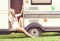 Young and beautiful hippy girl sitting on trailer at summer. Holiday, journey, vacation concept.