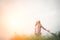 Young beautiful hipster woman in a flower field at sunset. Freed