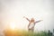 Young beautiful hipster woman in a flower field at sunset. Freed