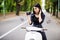Young beautiful hipster woman riding with photo camera on motorbike city street, taking pictures, summer europe vacation, travelin