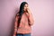 Young beautiful hispanic fashion woman wearing animal print sweater over pink background looking stressed and nervous with hands