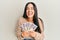 Young beautiful hispanic girl holding japanese yen banknotes smiling and laughing hard out loud because funny crazy joke