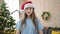 Young beautiful hispanic woman celebrating christmas standing with relaxed expression at home