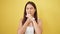 Young beautiful hispanic woman coughing over isolated yellow background