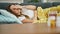 Young beautiful hispanic woman lying on the sofa sick with tissues and pills on the table at home