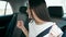 Young beautiful hispanic woman passenger sitting on car dancing at street