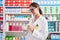 Young beautiful hispanic woman pharmacist smiling confident make mixture at pharmacy