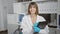 Young beautiful hispanic woman scientist taking notes smiling at laboratory