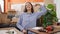 Young beautiful hispanic woman sitting on the floor assembling new table proud of herself at new home