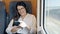 Young beautiful hispanic woman smiling using smartphone sitting at train station