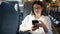 Young beautiful hispanic woman smiling using smartphone sitting at train station