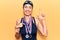 Young beautiful hispanic woman wearing swimmer swimwear and winner medals smiling with an idea or question pointing finger with