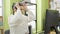 Young beautiful hispanic woman working taking glasses off at the office