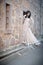 Young beautiful Indian Woman standing against stone wall outdoors