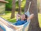 young beautiful lady posing while lying on hammock,