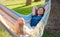 young beautiful lady posing while lying on hammock,