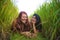 Young beautiful latin woman and her attractive red hair girlfriend both girls enjoying Summer holidays together on rice field