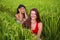 Young beautiful latin woman and her attractive red hair girlfriend both girls enjoying Summer holidays together walking on rice