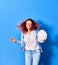 Young beautiful latin woman holding architect hardhat smiling happy