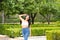 Young and beautiful Latin woman from South America walks among the trees and vegetation of the park. The woman is smiling and