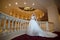 Young beautiful luxurious woman in wedding dress posing in luxurious interior. Bride with huge wedding dress in majestic manor