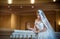 Young beautiful luxurious woman in wedding dress posing in luxurious interior. Bride with huge wedding dress in majestic manor