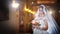 Young beautiful luxurious woman in wedding dress posing in luxurious interior. Bride with long veil holding her wedding bouquet