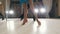 Young beautiful man and woman dancing and rehearsing Latin American dance in costumes in the Studio, focus on feet