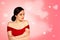 Young Beautiful Model Girl in Red Dress on Light Pink Background with Hearts. Concept Valentine`s Day. Holiday Card.