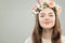 Young Beautiful Model Woman in Flowers Wreath Portrait. Healty Skin, Brown Hair, Makeup and Flowers