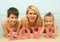 Young beautiful mother with children lying on the beach with word Love