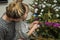 Young beautiful mother with her charming daughter dress up toys and garlands Christmas tree preserving family values and tradition