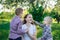 Young beautiful mother playing with his two sons. Children stroking mom`s head. Love and care