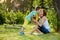 Young beautiful mother, sitting in a garden, little boy, her son