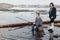 Young, beautiful mother and son have fun fishing on the lake