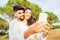 Young beautiful multiracial couple in love taking selfie in nature enjoying vacation moments sharing photos on social networks.