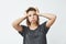 Young beautiful nervous upset girl thinking holding head over white background.