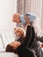 Young beautiful parents play with their daughter infant in the room. Happy family